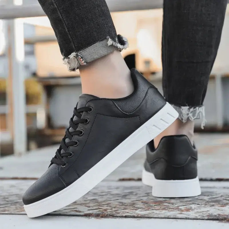 Man wearing Atlas Casual Sneakers, showcasing stylish black design, perfect for comfortable everyday wear and travel.