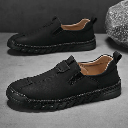 Catania Genuine Leather Loafers with hand-stitched design, elastic sides, and rugged outsole, perfect for elegant slip-on comfort and formal style.