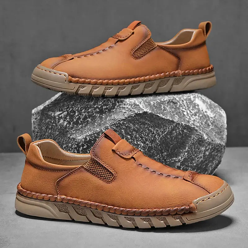 Catania Genuine Leather Loafers with hand-stitched details, elastic panels, and rugged outsole showcasing elegance and comfort in men's slip-on design.