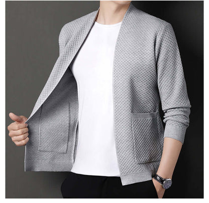 Man wearing Orvieto Cardigan, a warm wool-blend men's winter sweater, showcasing open front and geometric knit for stylish layering.