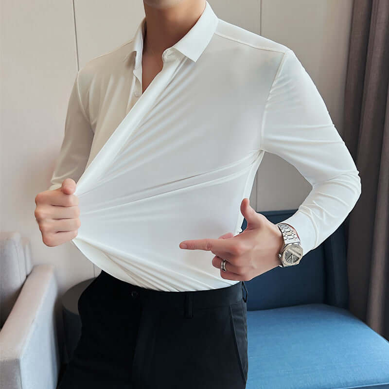 Man wearing a white men's wrinkle-free shirt displaying its stretchability